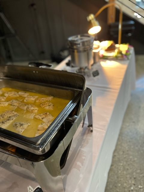 A buffet table with a tray of food on it