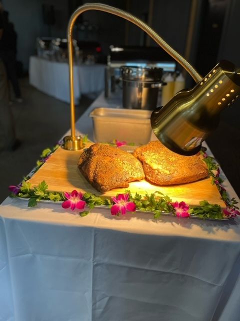 Two pieces of meat on a cutting board under a light