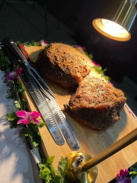 Two pieces of meat are sitting on a wooden cutting board