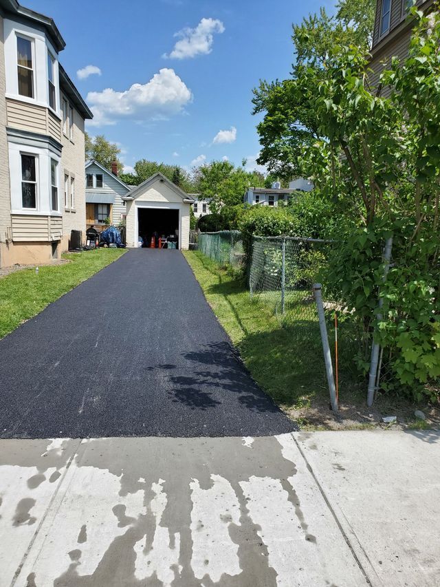 A driveway leading to a house with a garage