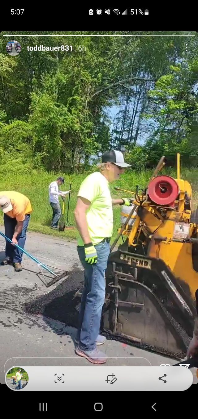 A group of men are working on a road.