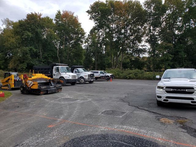 A white ram truck is parked in a parking lot