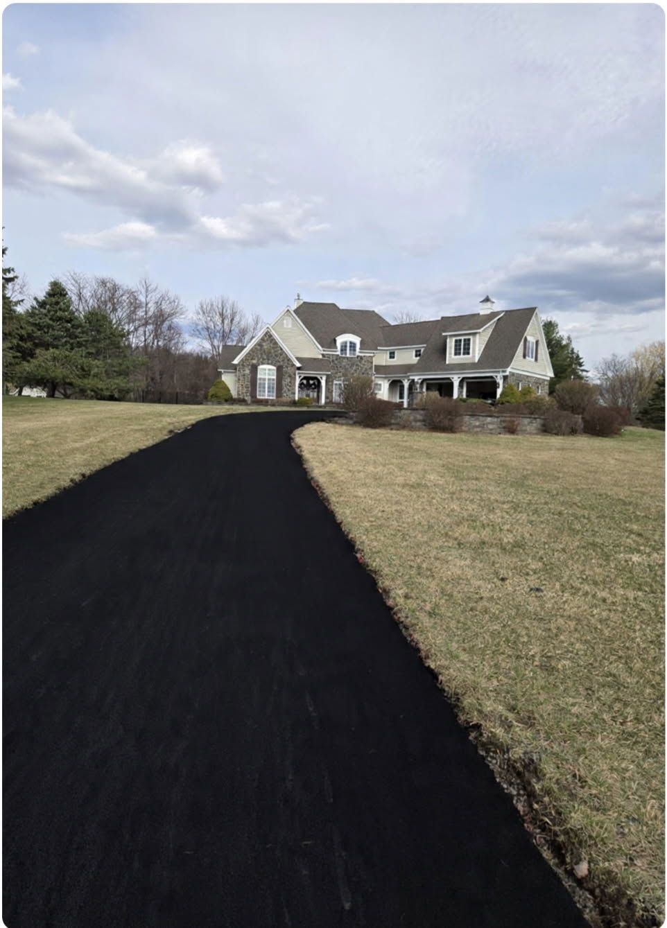 A man is walking down a driveway between two buildings