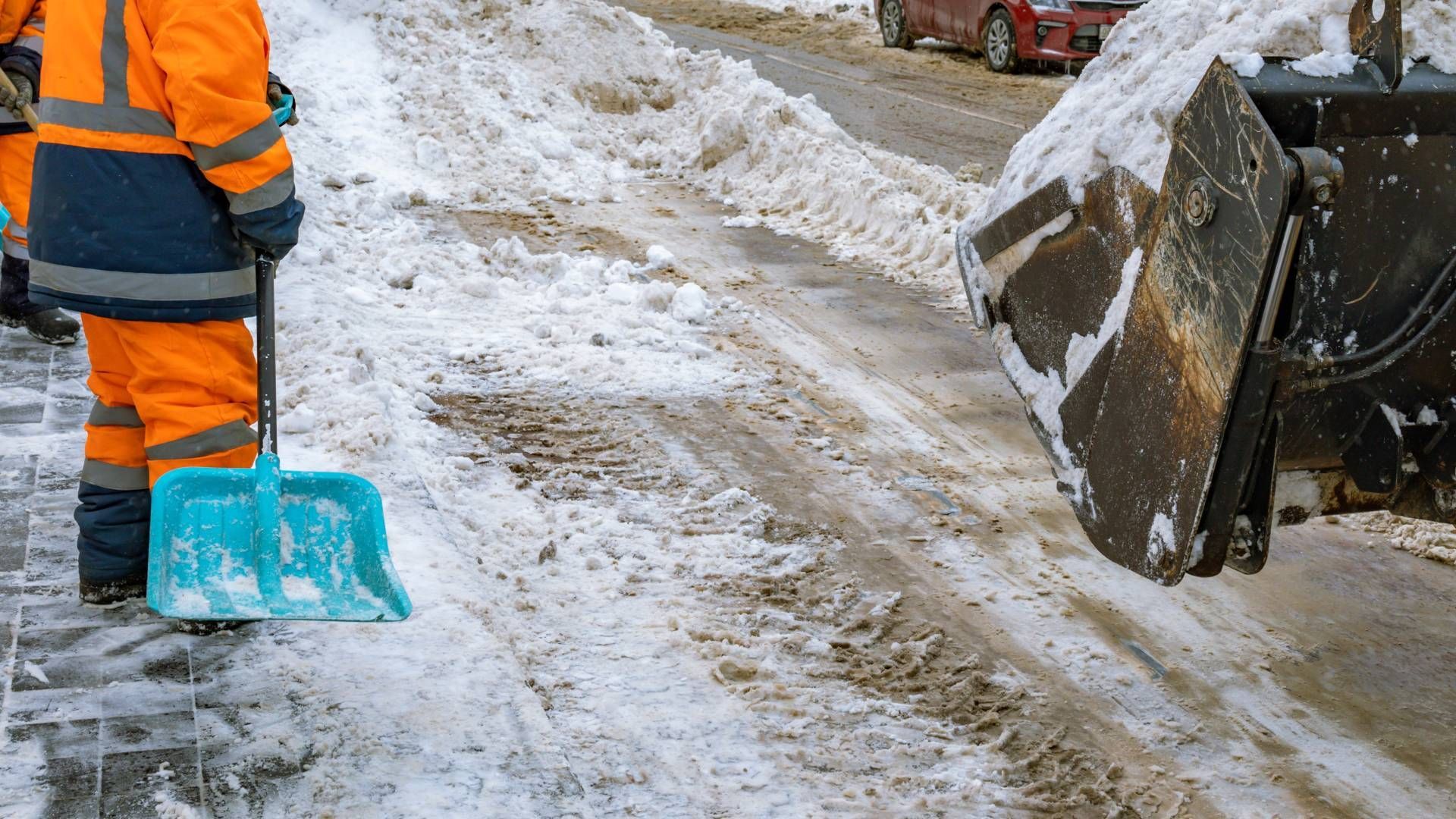 A man is sitting on a machine that has the word asphalt on it