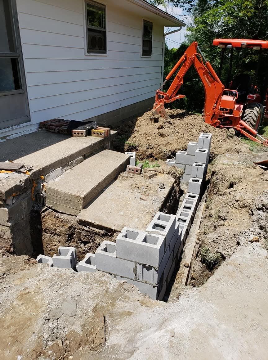 Two men are working on the roof of a house.