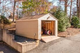 Outdoor storage shed with garage-style door for tools and equipment in backyard