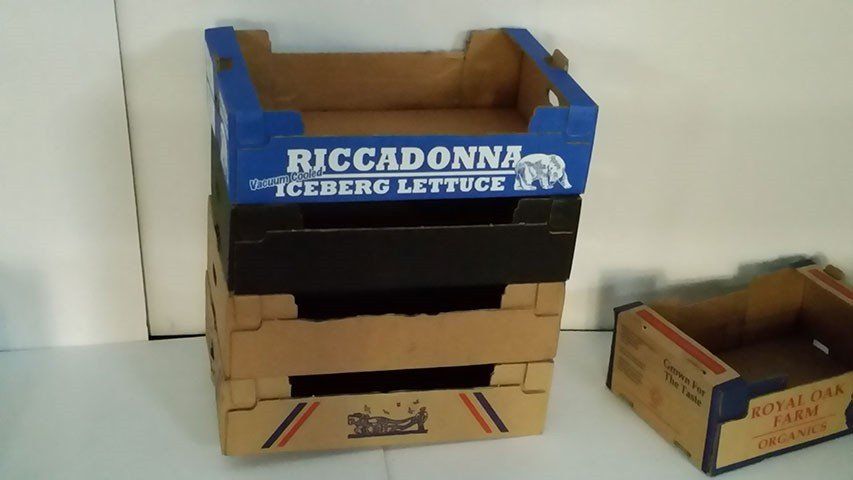 Different colours of cardboard crates stacked together