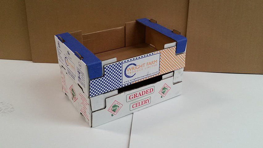 Two colourful fruit crates stacked on top of each other