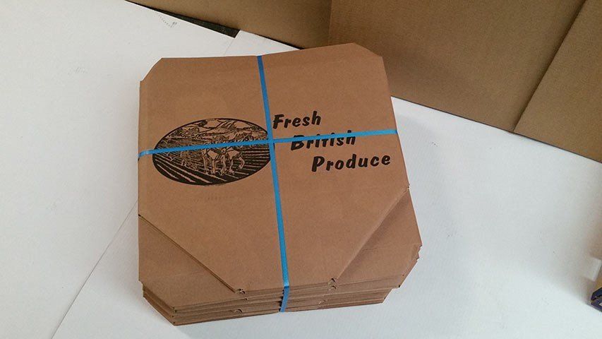 Flat packed cardboard packaging tied with blue cable ties
