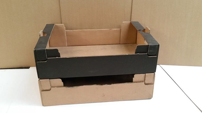 Plain black cardboard crate stacked on top of another uncoloured crate