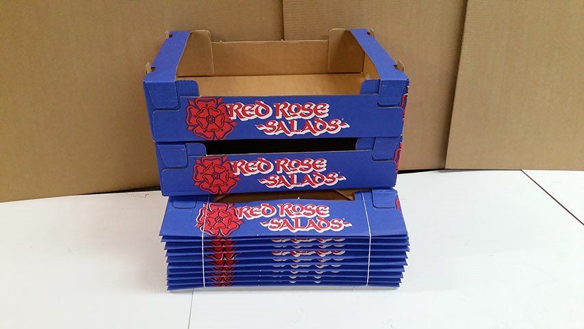 Cardboard boxes stacked on top of flat packed boxes