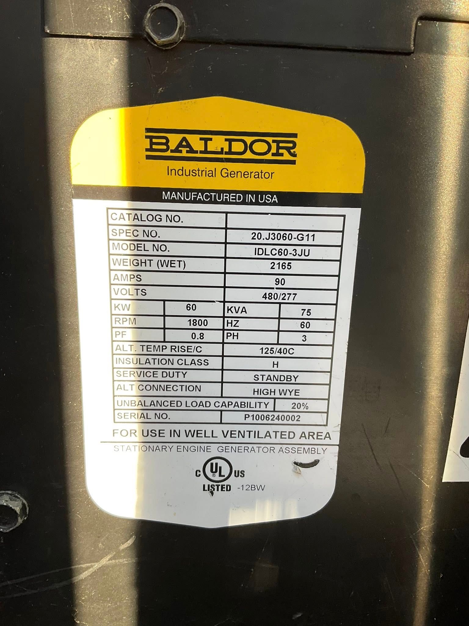 Close-up of a Baldor motor nameplate label with specifications on a black machine surface.