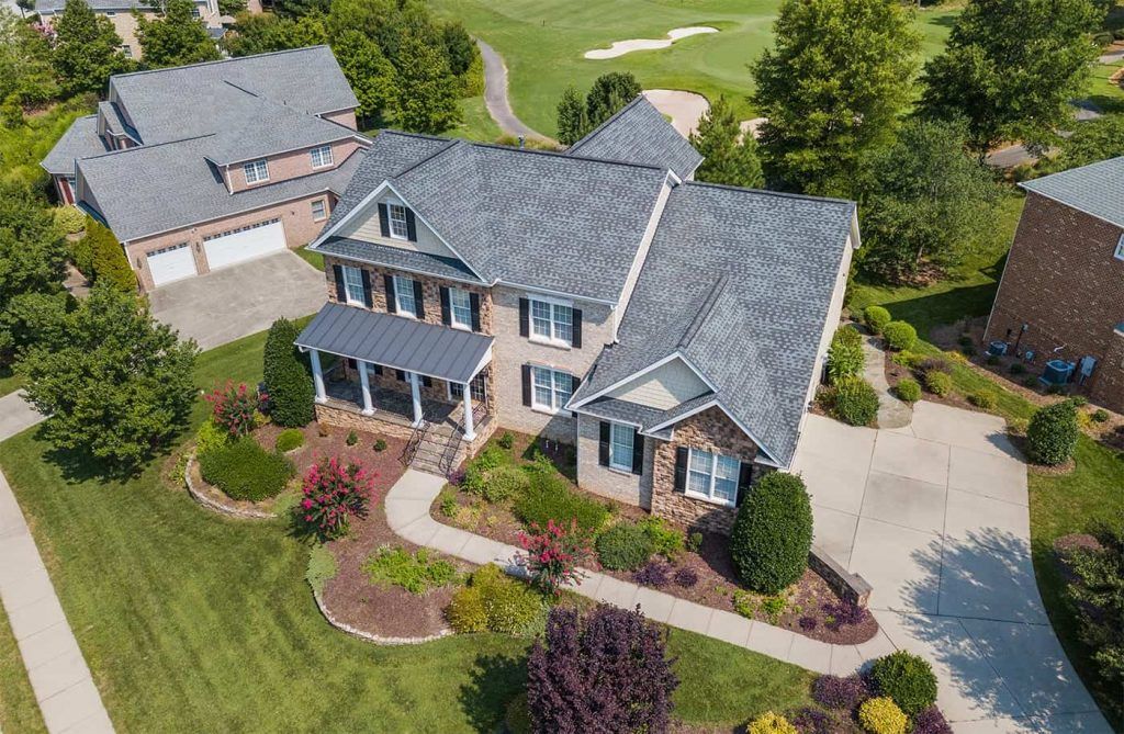 an aerial photo of a home in bentonville with its front yard freshly landscaped and rennovated.