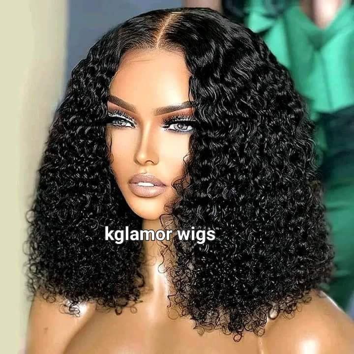 Curly black wig with shoulder-length curls and center part, styled on a mannequin head