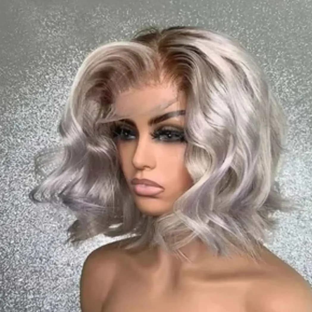 Portrait of a person with silver wavy hair and dramatic makeup against a gray textured background
