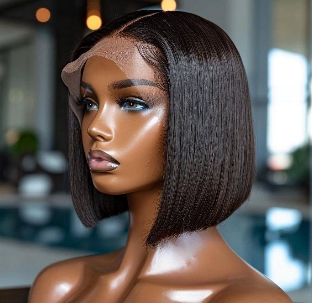 Portrait of a woman with a sleek bob and lace front, in a softly blurred indoor setting