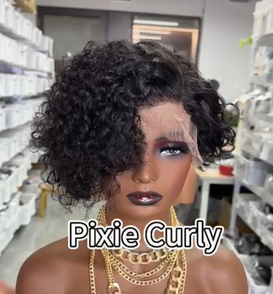 Curly pixie wig with dark makeup and gold necklaces in a wig shop aisle