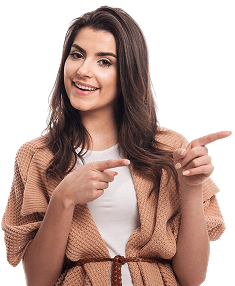 Smiling woman in a beige cardigan pointing left with both hands on a white background