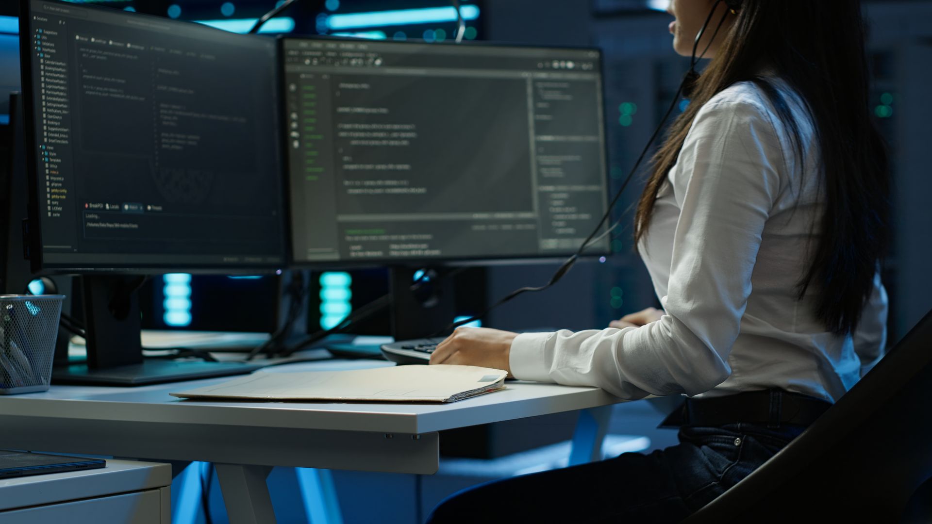 Minimal high-angle view of a worker providing IT support, working with computers in the office.