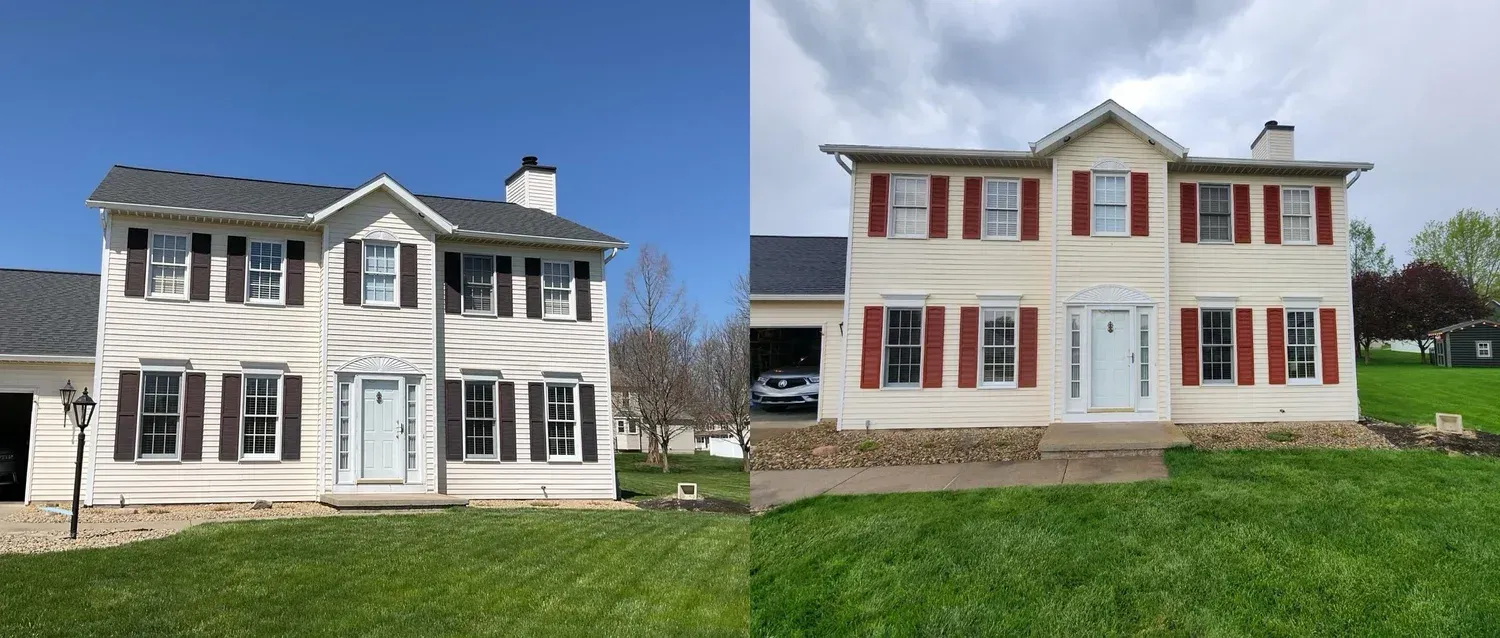 Two-story house with white siding and shutters. The shutters on the left are black, and the right are red.