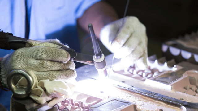 Man Soldering An Iron — DFW Airport, TX — Steel Service Center