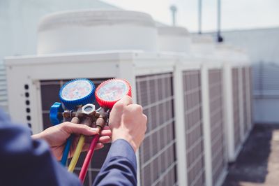 Commercial Electrician — Technician is Checking Air Conditioner in Chiefland, FL