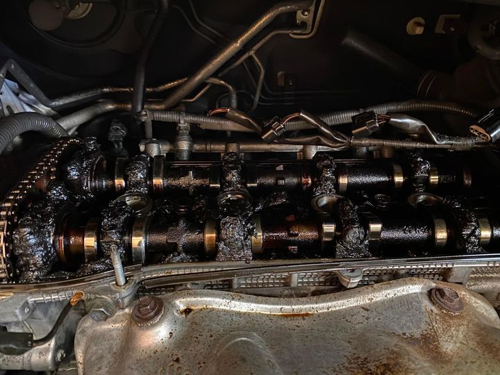 A Man Is Working On A Car In A Garage — Uncle Tonys Auto And Mechanical In Currumbin Waters, QLD
