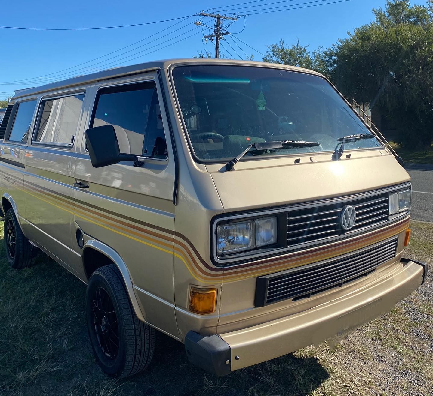 A Man is Writing on a Paperin Front of a Car — Uncle Tonys Auto And Mechanical In Currumbin Waters, QLD