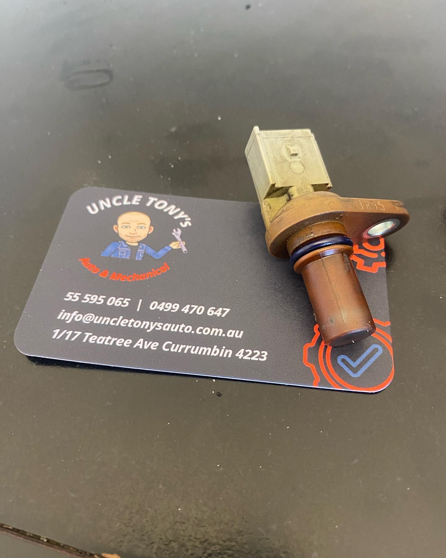 A Red Car Is Sitting On A Lift In A Garage — Uncle Tonys Auto And Mechanical In Currumbin Waters, QLD