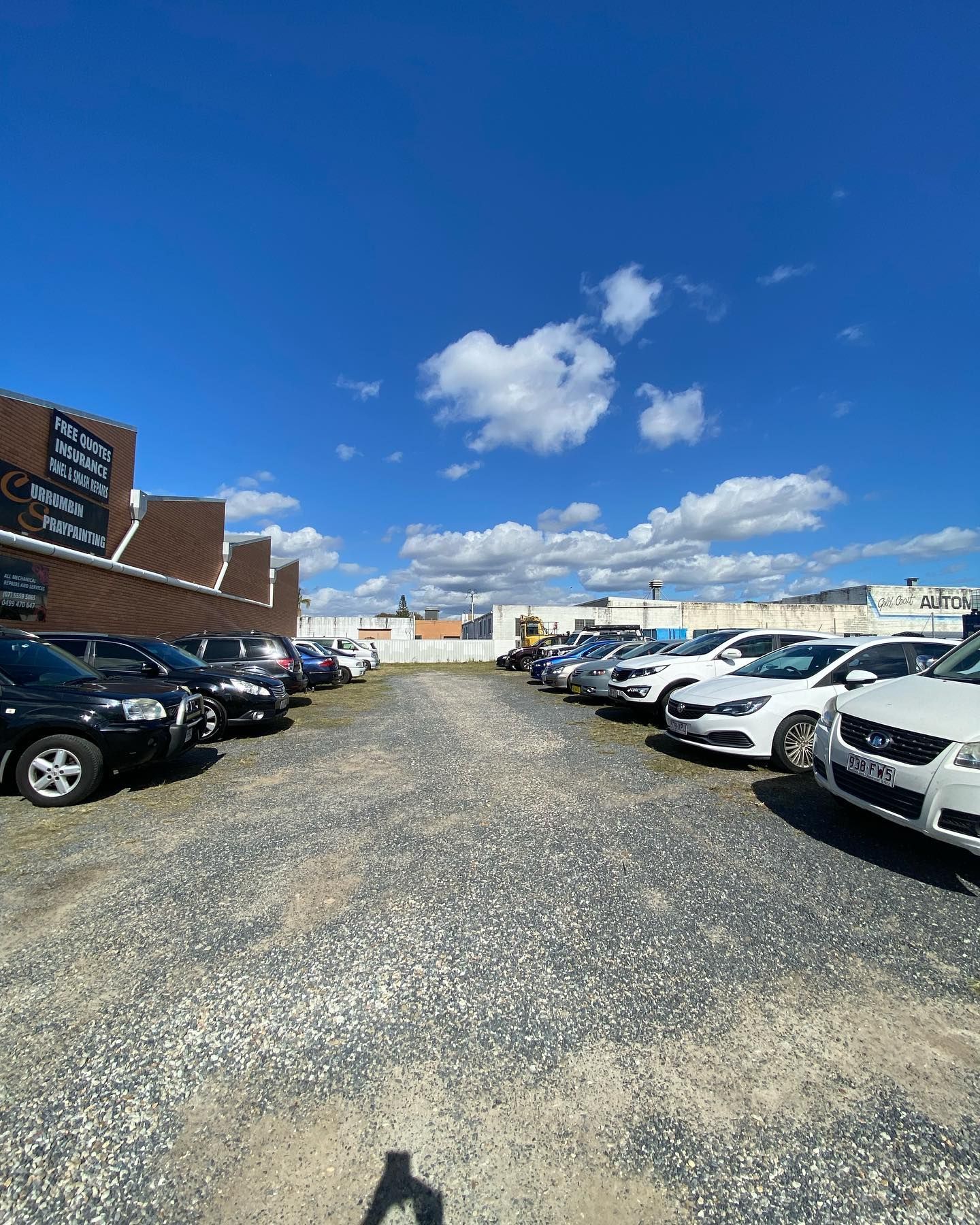 A Person Is Holding A Tablet In Front Of A Machine — Uncle Tonys Auto And Mechanical In Currumbin Waters, QLD