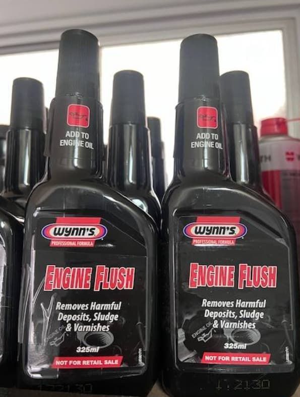 Two Bottles Of Engine Flush Are Sitting On A Table — Uncle Tonys Auto And Mechanical In Currumbin Waters, QLD