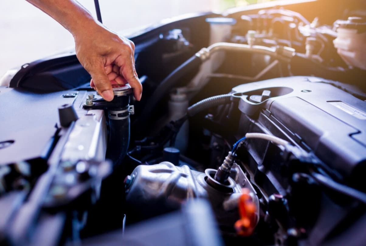 A Person Is Opening The Hood Of A Car To Check The Coolant Level — Uncle Tonys Auto And Mechanical In Currumbin Waters, QLD
