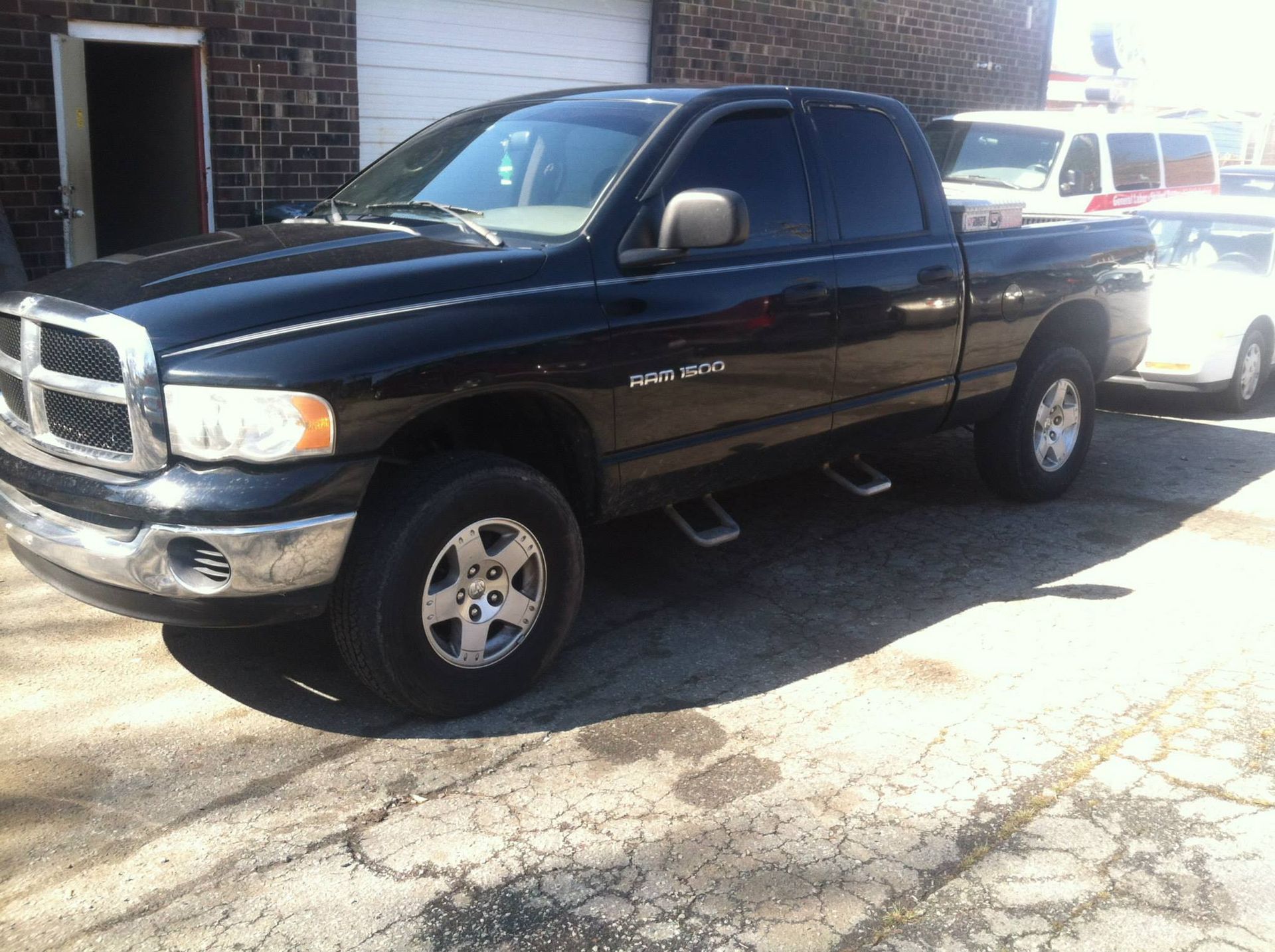 Black Dodge Ram pickup truck parked outdoors.