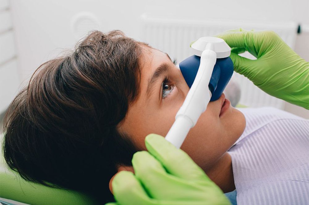 Medical professional uses oxygen mask on a patient.