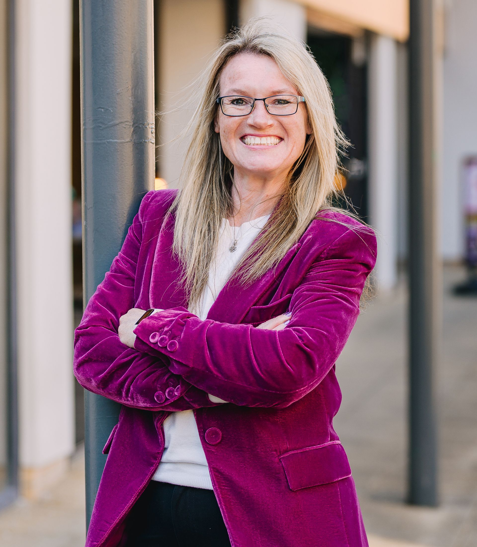 Zena standing with arms crossed and smiling