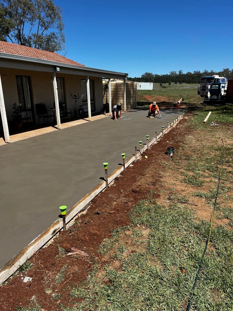 A Concrete Driveway is Being Built in Front of a House — All Aspects Concreting & Earthworks Pty Ltd in Dubbo, NSW
