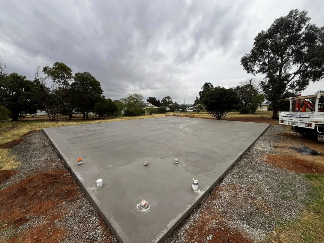 A Truck is Parked on the Side of a Concrete Driveway — All Aspects Concreting & Earthworks Pty Ltd in Dubbo, NSW