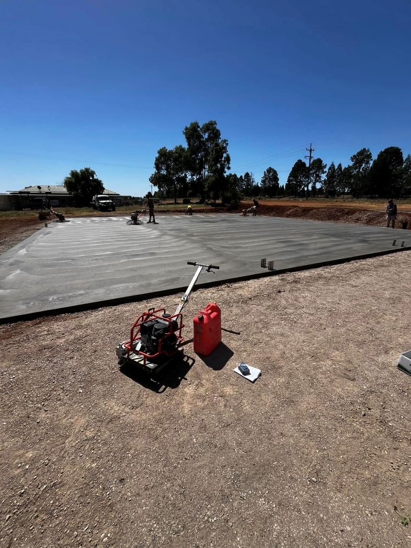 A Red Gas Can is Sitting on the Ground Next to a Concrete Slab — All Aspects Concreting & Earthworks Pty Ltd in Dubbo, NSW