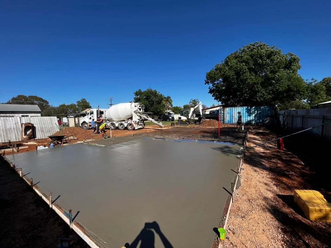A Concrete Truck is Pouring Concrete Into a Concrete Slab — All Aspects Concreting & Earthworks Pty Ltd in Dubbo, NSW