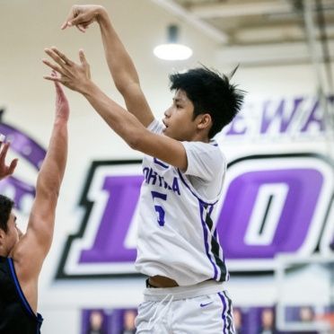 A philadelphia basketball player reaches for the ball