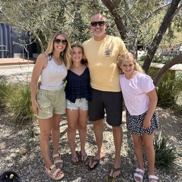 A family posing for a picture in front of a tree