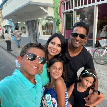 A group of people posing for a picture in front of a store