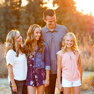 A group of people standing next to each other in a field.
