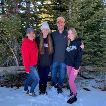 A group of people posing for a picture in the snow