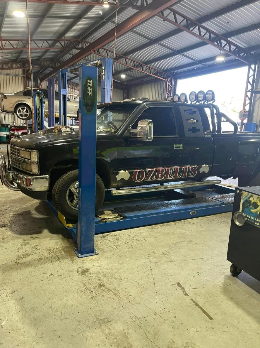A Truck is Sitting on a Lift in a Garage — Chrisp Performance in Emerald, QLD