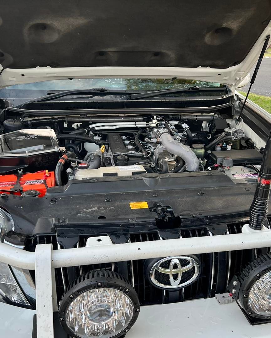 Hood of A White Truck Is Open and The Engine Is Visible — Chrisp Performance in Emerald, QLD