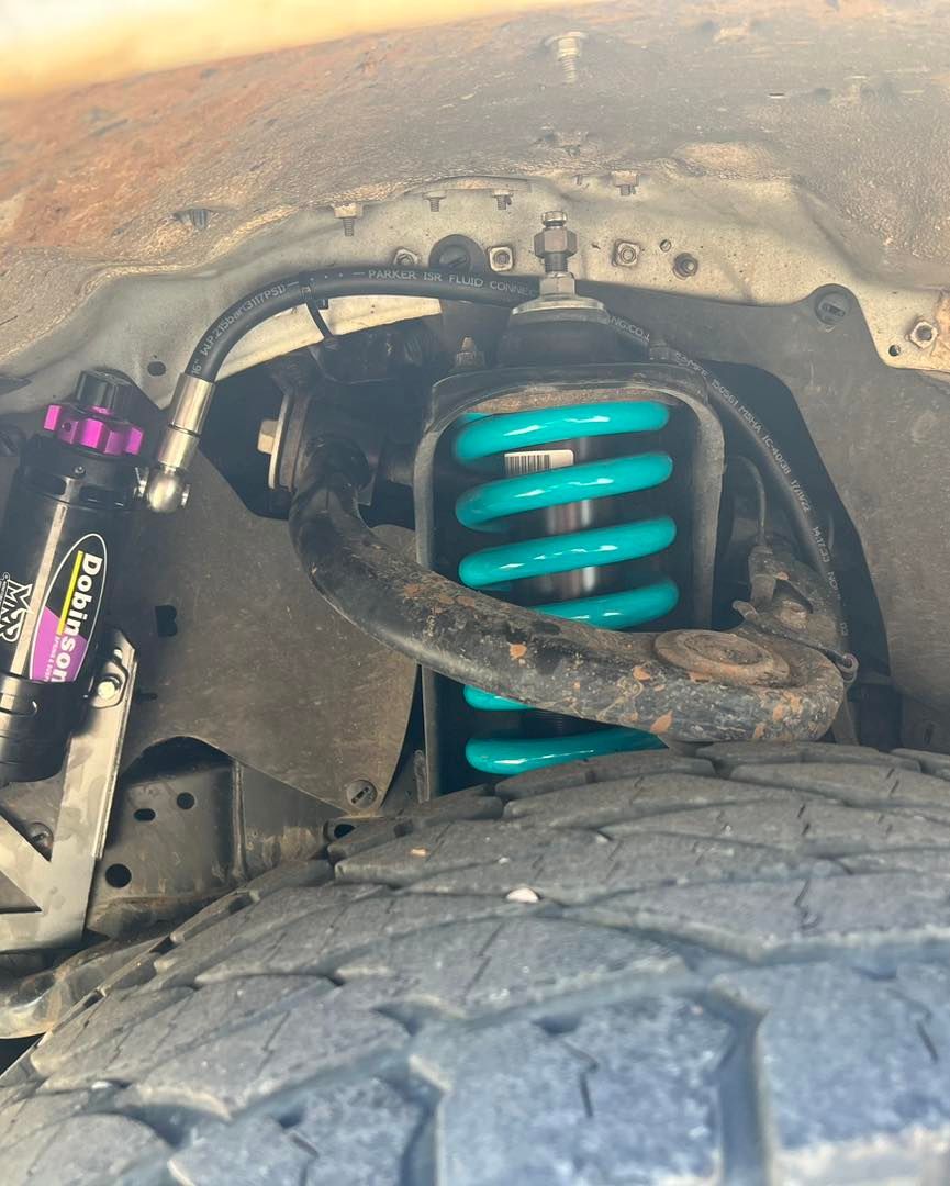 Close Up Of the Underside of A Car With A Shock Absorber And A Tire — Chrisp Performance in Emerald, QLD
