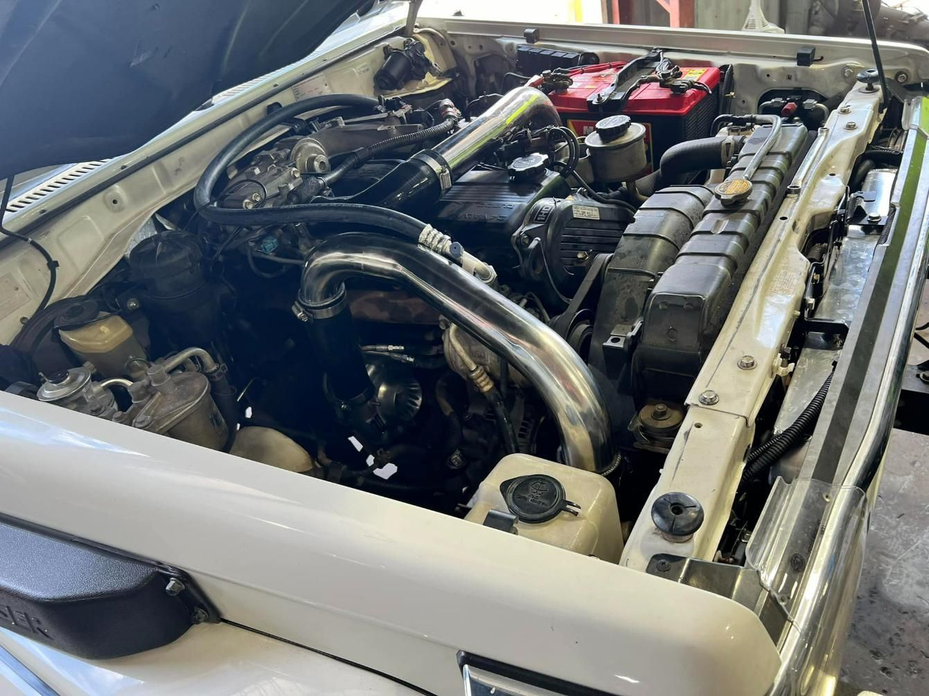 Engine Of A White Car With Hood Open — Chrisp Performance in Emerald, QLD