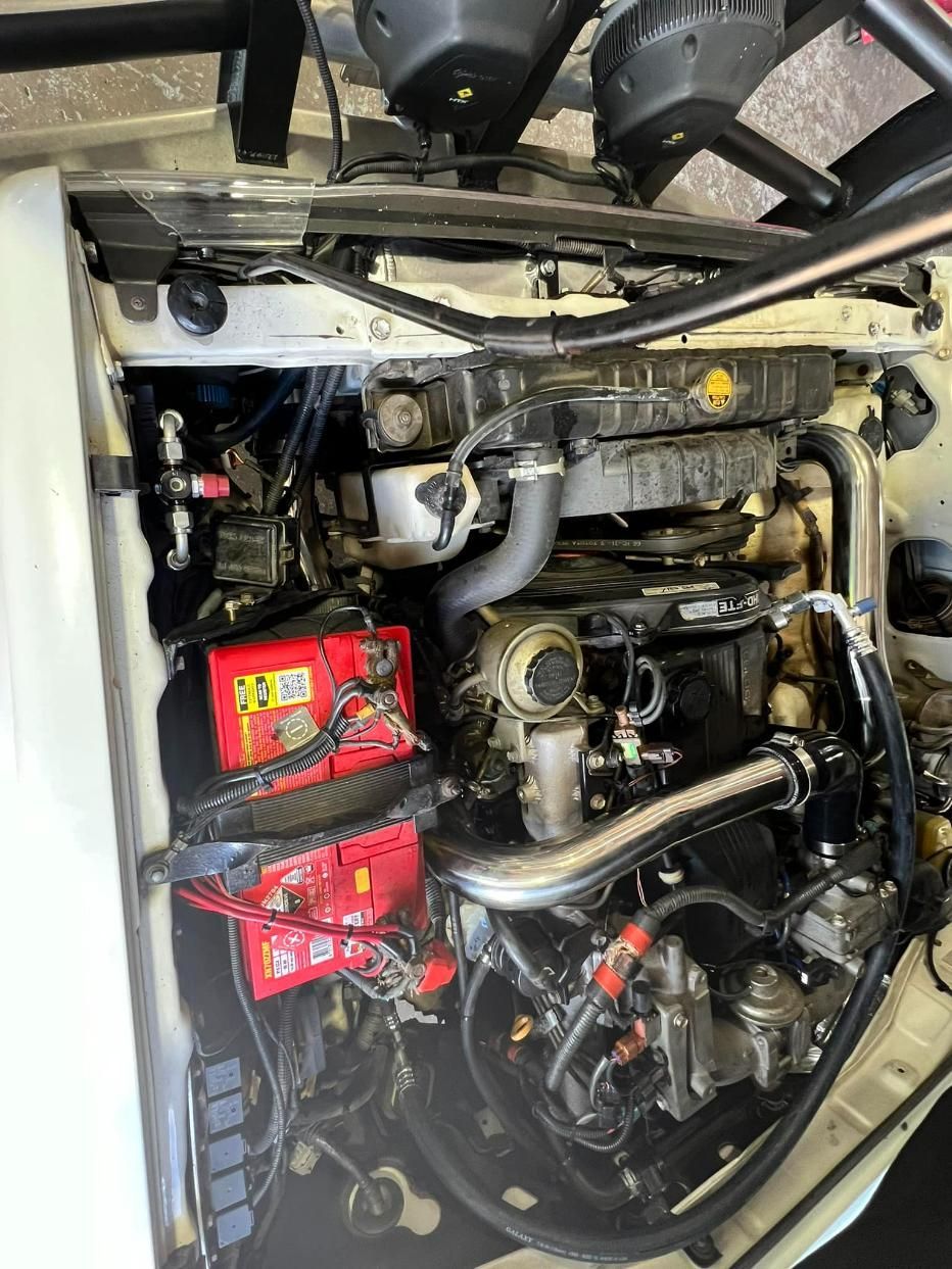 Close Up Of A Car Engine With Red Battery — Chrisp Performance in Emerald, QLD