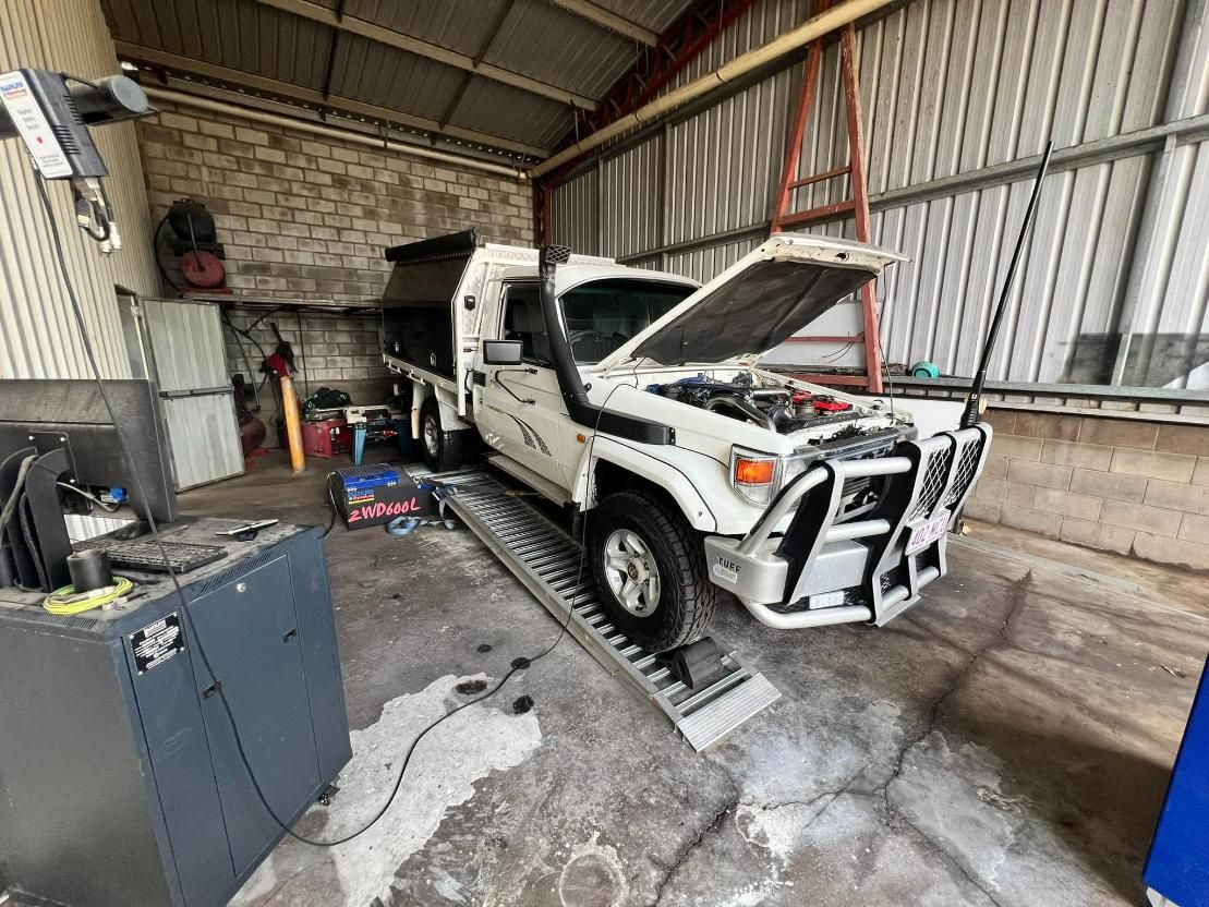 White Truck Is Parked In A Garage With Its Hood Open — Chrisp Performance in Emerald, QLD